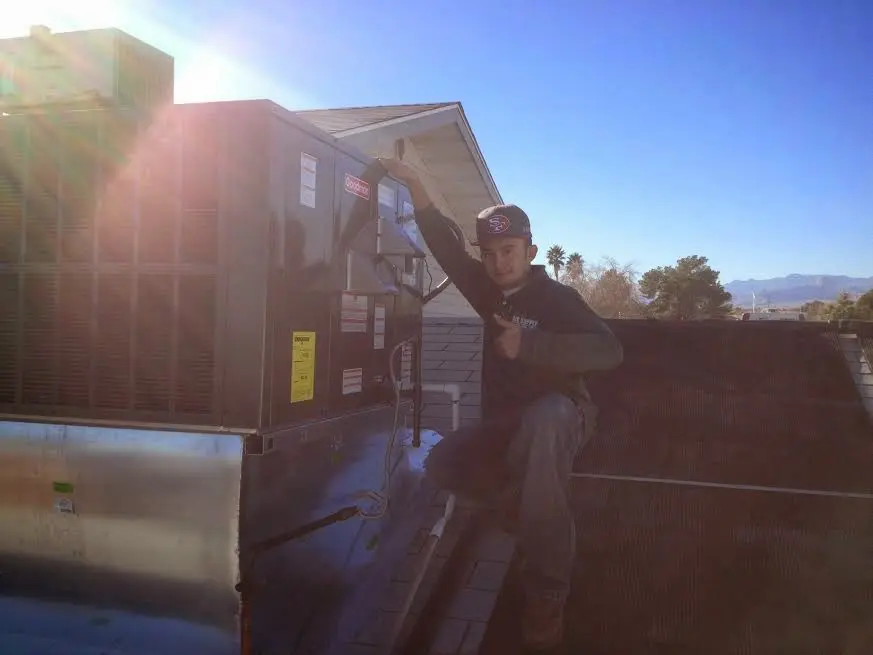 HVAC technician performing AC Tune-Up on a rooftop unit in Signal Mountain